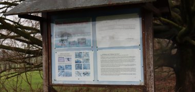 Old information board at the stone box grave